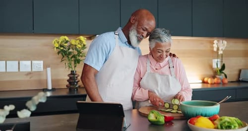 Loving Senior Couple Preparing Food Together in Kitchen