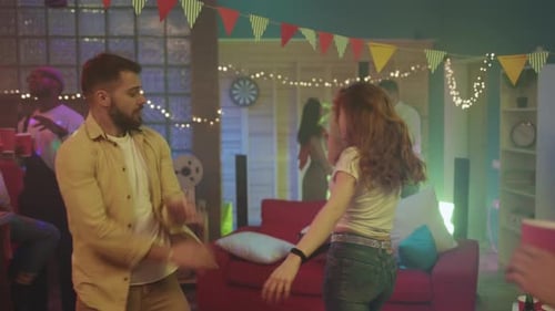 Young Adults at a Lively Party Dancing Together