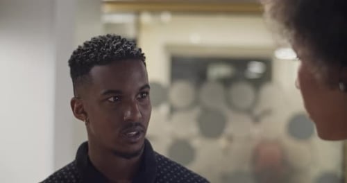 Black Man Speaking with Colleague