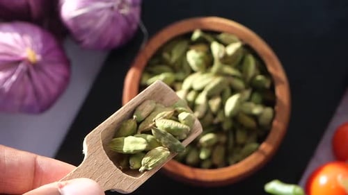 Wooden Bowl with Fragrant Cardamom Pods