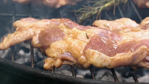 Succulent Pork Steak with Rosemary Sprigs Grilling to Perfection on Hot Coals
