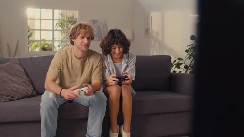 Couple Plays Video Games Together on Couch