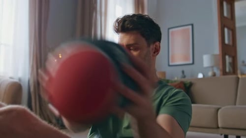Handsome Athlete Training Abs with Ball at Home Closeup Man Making Exercises