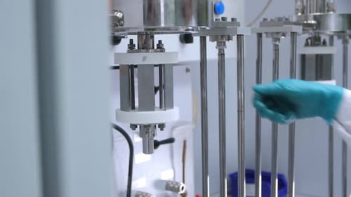 Assistant Pushes Lever to Start Automatic Machine in Shop