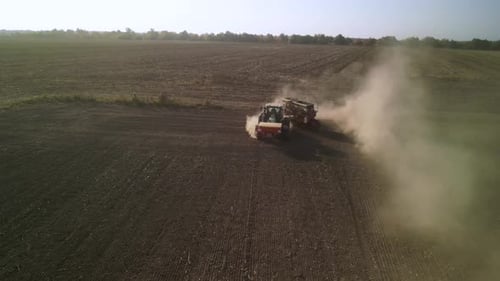 Tractor on the field seeding wheat