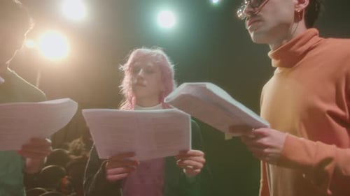 Actress Rehearsing on Theater Stage with Director and Troupe