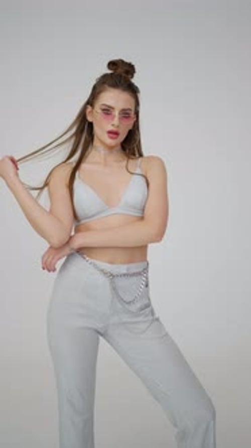 Model in Fashionable Silver Outfit Posing Concept of Fashion Style Confidence