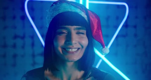 Cyberpunk Lady in Red Santa Hat Grimaces and Smiles Gently