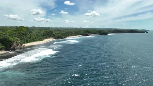 Aerial view of beautiful empty tropical beach and sea without visitors in Yogyakarta, Indonesia.