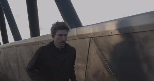 Adult man running athlete sprinting workout challenge training endurance in urban city