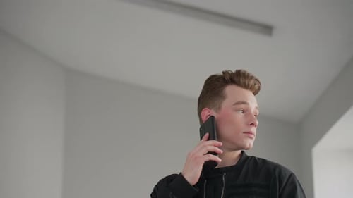 Young Adult Talking on Phone Indoors
