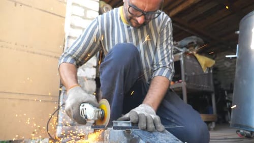 Mechanic Grinding Metal Using Circular Saw Worker Cutting Detail in Garage or Workshop Man Sawing