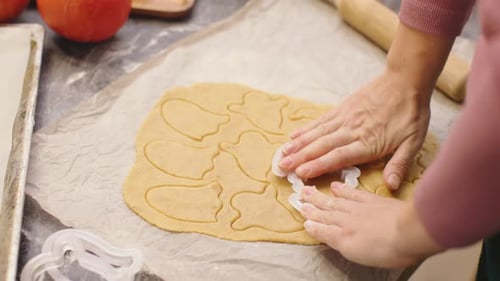 Hands Cutting Cookie Shapes from Dough at Home