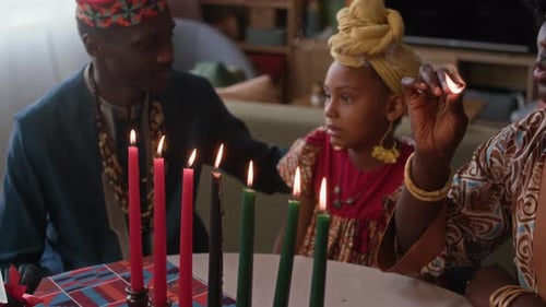 Family lights candles together at home