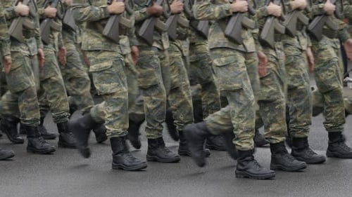 Soldiers Marching in Camouflage with Weapons