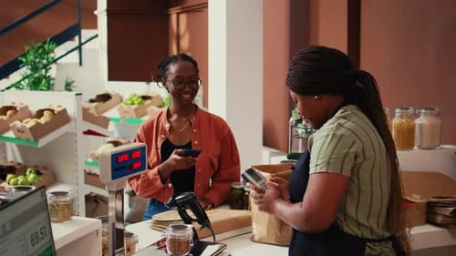 Woman Pays with Card in Local Store