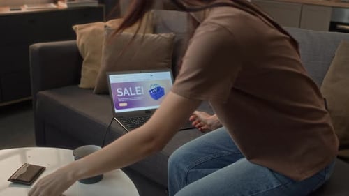 Woman on Couch Shopping Online with Laptop