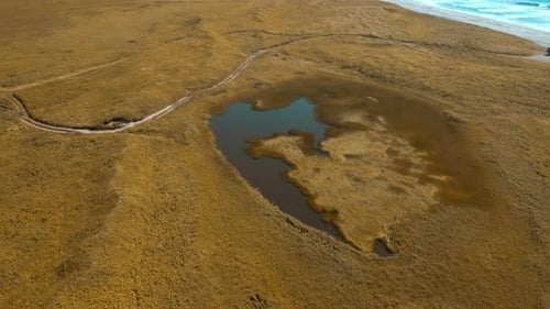 Idyllic Countryside Landscape with Tiny Lake in Dried Yellow Field Clip Autumn Valley and Sea Shore