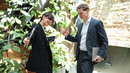 Business Partners Celebrate Successful Deal in Modern Office