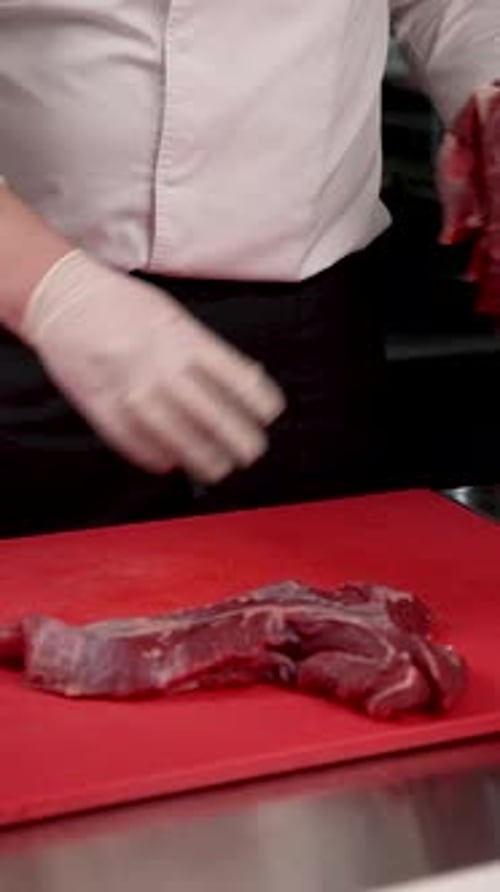 Chef Preparing Raw Meat on Cutting Board