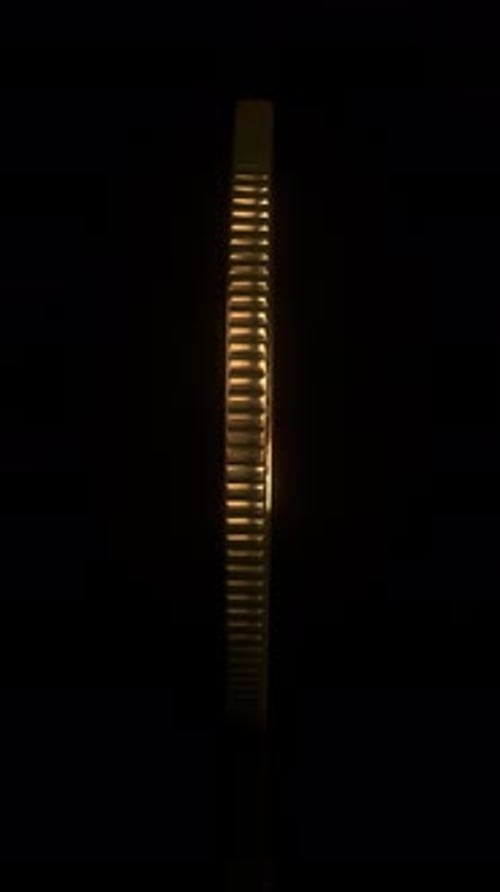 Rotating Golden Bitcoin Coin on Reflective Black Background