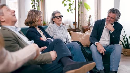 Group of Adults Talking on Couch Indoors at Home