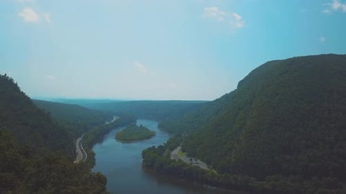 Aerial shot of a highway by the riverside