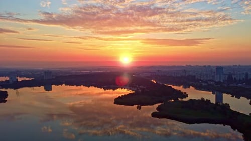 Sunrise on river with vibrant clouds