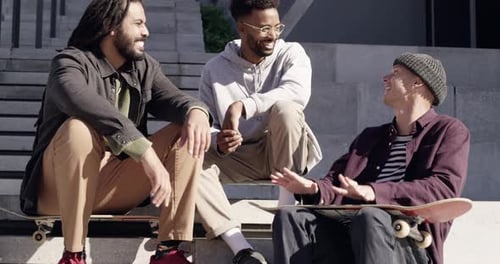 4k video footage of three skaters chatting to each other at the skatepark