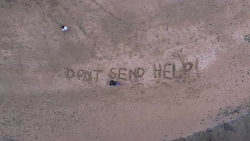 Aerial View of Tropical Beach with Message Written in Sand
