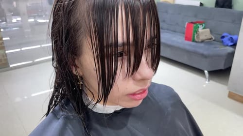Woman Getting a Haircut with Wet Bangs in Salon