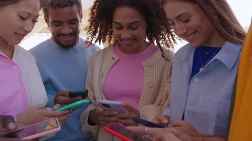 Friends Smiling and Using Smartphones Together