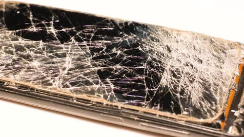 Damaged Cell Phone with Shattered Screen Close Up