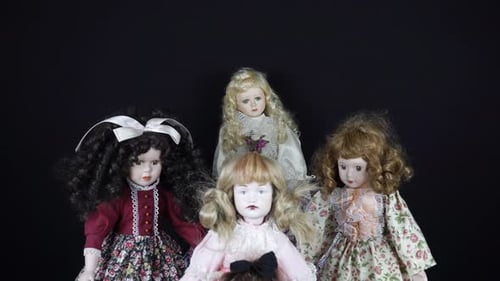 Group of Porcelain Dolls on Black Background