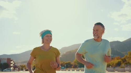 Active Senior Couple Jogging on Sunny Day