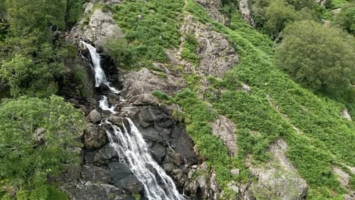 Waterfall Cascading Down Lush Green Mountainside