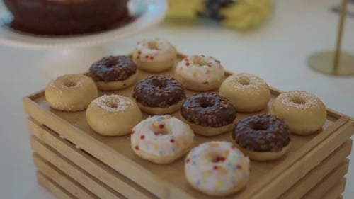Mini assorted donuts on wooden tray at dessert buffet