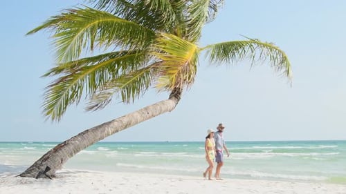 Tourist Couple Walk In Tropical Beach Look At Camera