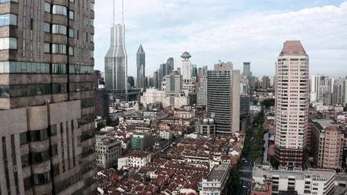 Aerial: lowering view beside Shanghai city tower skyscraper