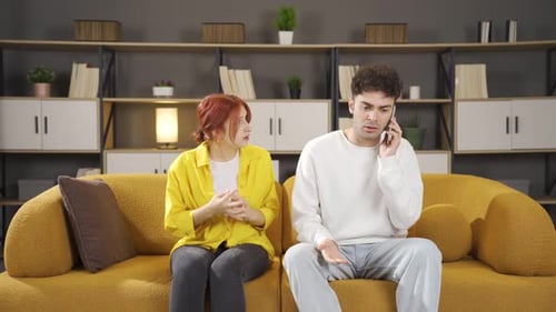 Distraught Couple on Couch During Difficult Conversation