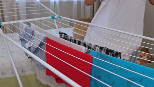 Woman Hanging Laundry on Foldable Drying Rack