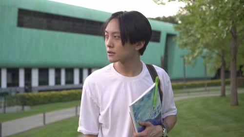Young Asian Man Against the Backdrop of a College
