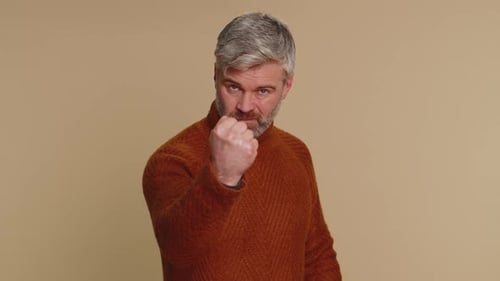 Man Making a Fist Gesture Come Closer