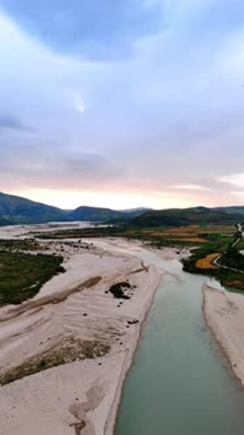 Picturesque landscape of Albania from top view. Drone footage over the narrow river with sandy banks