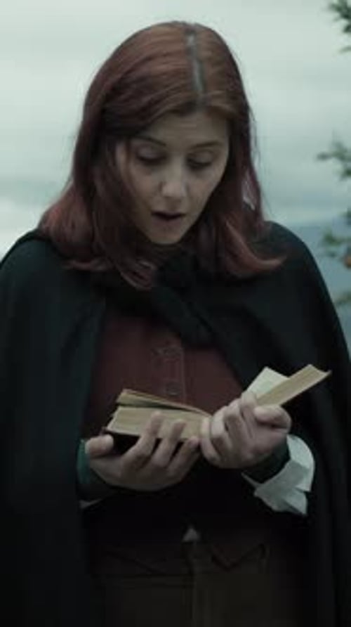 Person Reads Old Book in Overcast Natural Setting