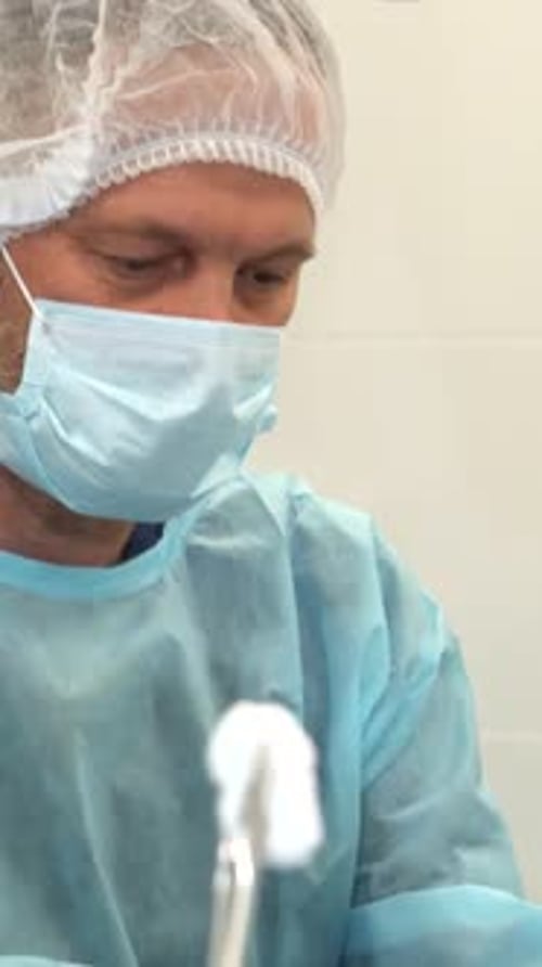Healthcare Worker Preparing Surgical Instruments in Hospital