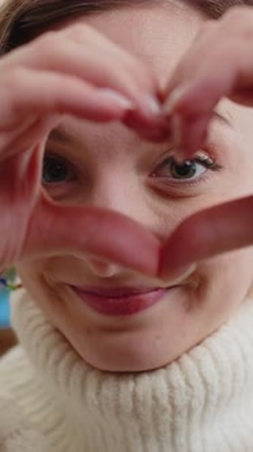Smiling Woman Makes Heart Shape With Hands