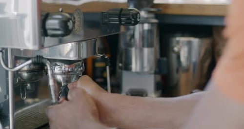 Closeup of Barista Using Coffee Machine Male Hands Preparing Fresh Drink at Counter in Cafe