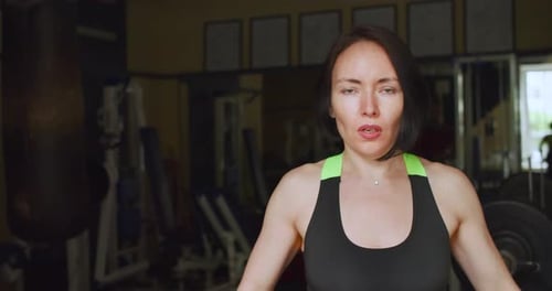 Footage of a Fit Middle Aged Caucasian Woman During Gym Workout