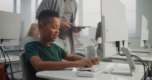 Smart Boy Using Computer Doing 3D Design Project Teacher Helping Young Elementary School Student
